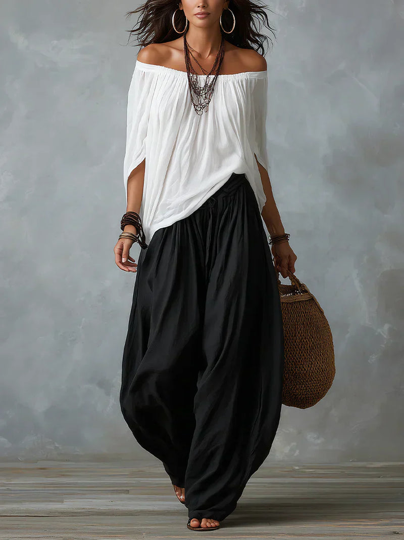 Completo Aurora con top asimmetrico e pantaloni palazzo in nero